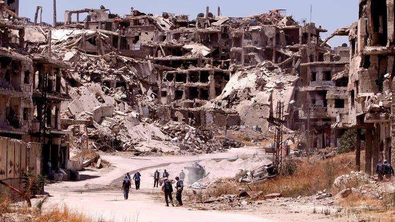 Workers collect the rubble of damaged buildings to be recycled and reused for reconstruction, under the supervision of the United Nations Development Program (UNDP) in the Homs, Syria.  –Courtesy photo