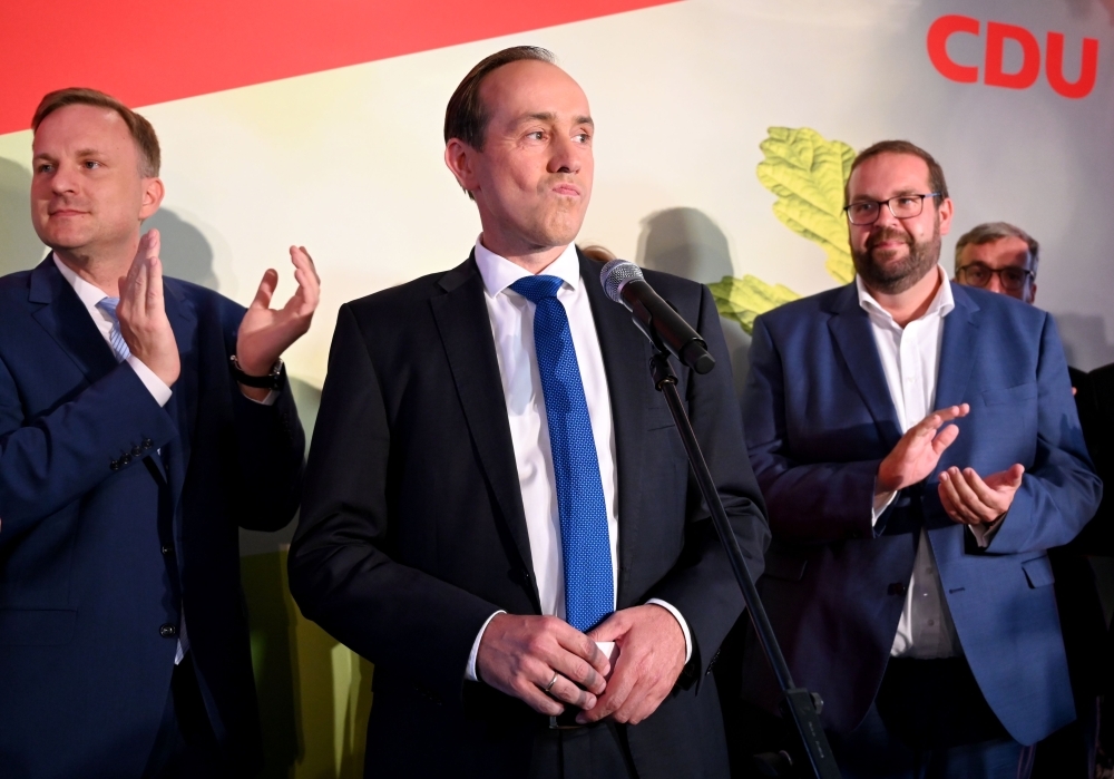 Ingo Senftleben, top candidate of his conservative Christian Democratic Union (CDU) party for the  state elections in Brandenburg is applauded on stage after the first exit polls during an electoral party on Sunday in Potsdam.  — AFP