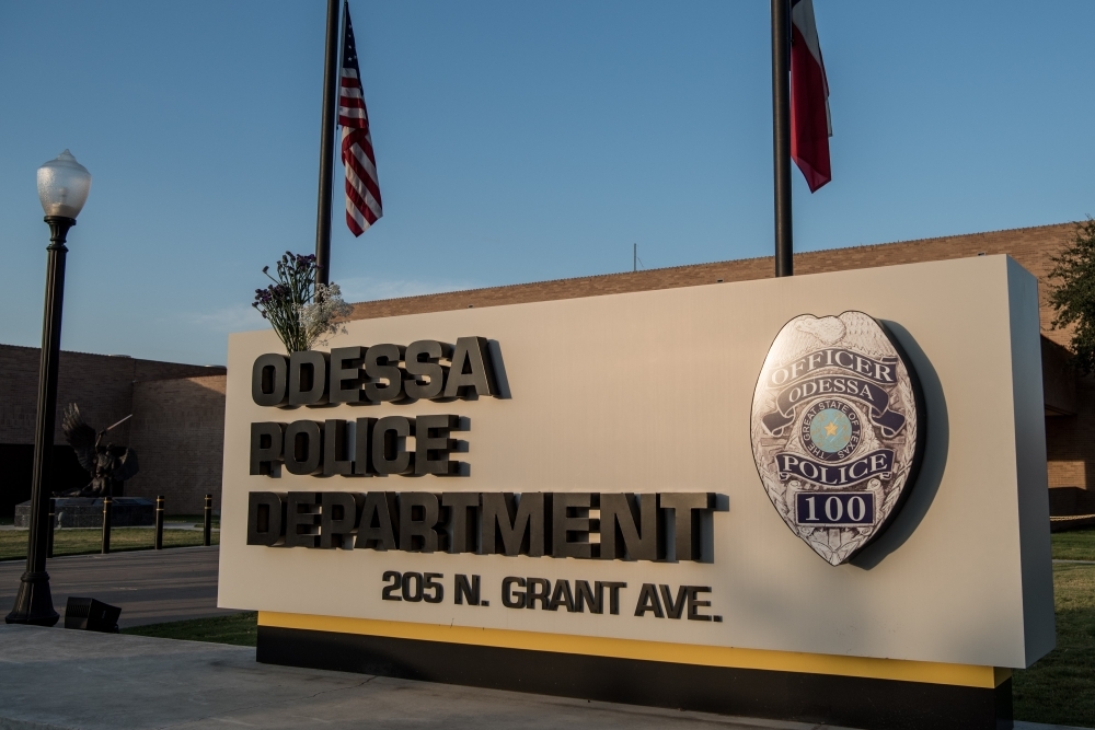 Flowers hang on the Odessa Police Department sign following a deadly shooting spree on Sunday in Odessa, Texas. Seven people had been killed, in addition to the gunman and at least 21 others were wounded, including three law enforcement officers after a gunman went on a rampage. — AFP