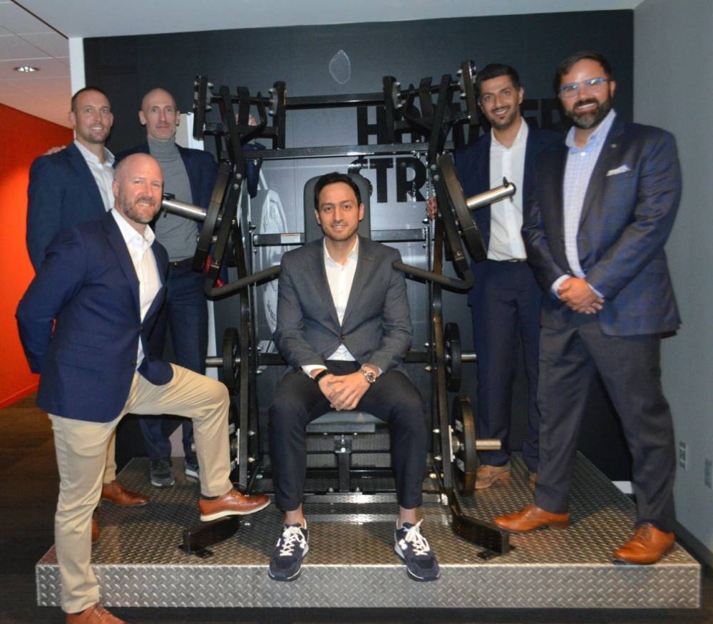 Chris Clawson (left), President of Life Fitness, and Fahad Al-Haqbani (middle), CEO of Armah Sports, pose with other company executives at the signing of agreement 