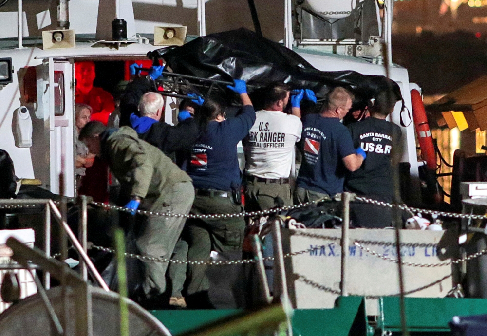 Rescue personnel return to shore with the victims of a pre-dawn fire that sank a commercial diving boat off the coast of  Santa Barbara, California on Monday. -Reuters