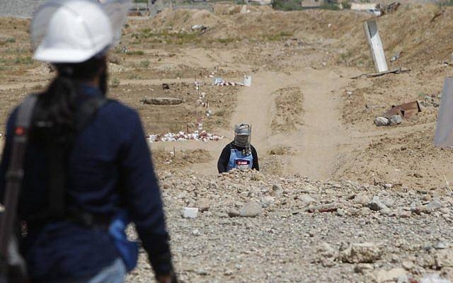 Iraqi mine clearers scan an agricultural area on August 25, 2019 near Baiji, Iraq. -AFP
