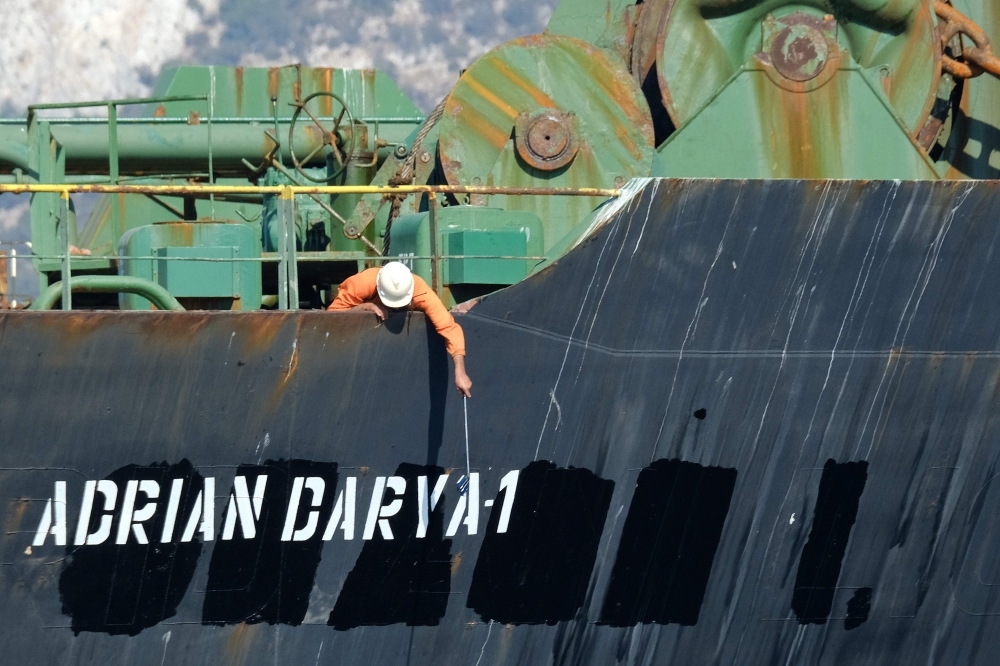 A crew member checks the new name of Iranian oil tanker Adrian Darya, formerly known as Grace 1, off the coast of Gibraltar, in this Aug. 18, 2019 file photo. — AFP