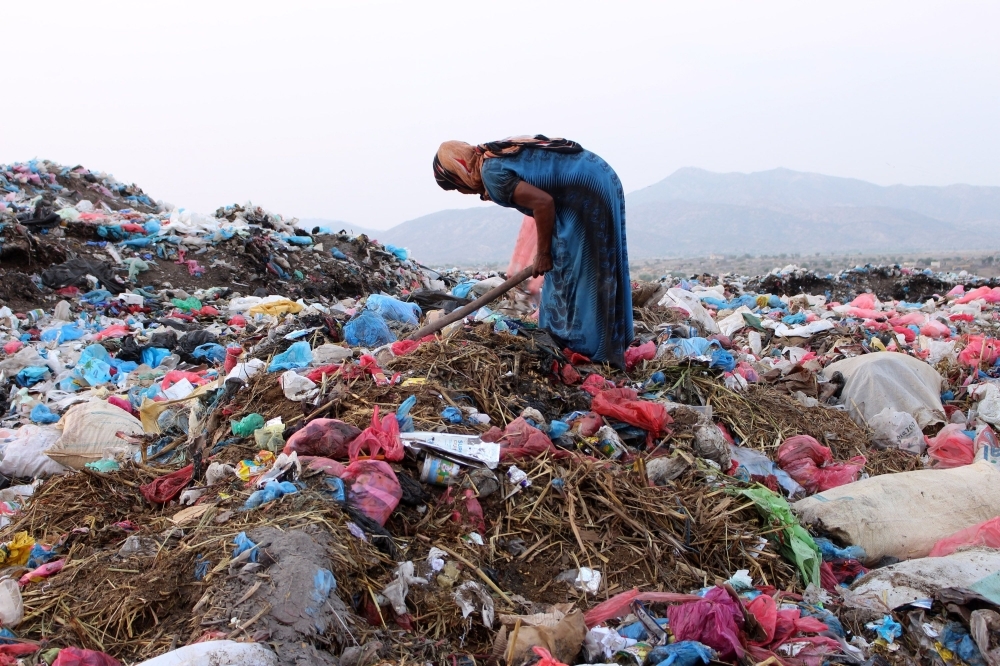 A Yemeni woman searches for recyclable items in a rubbish dump in the Abs district of the northwestern Hajjah province on Monday. — AFP