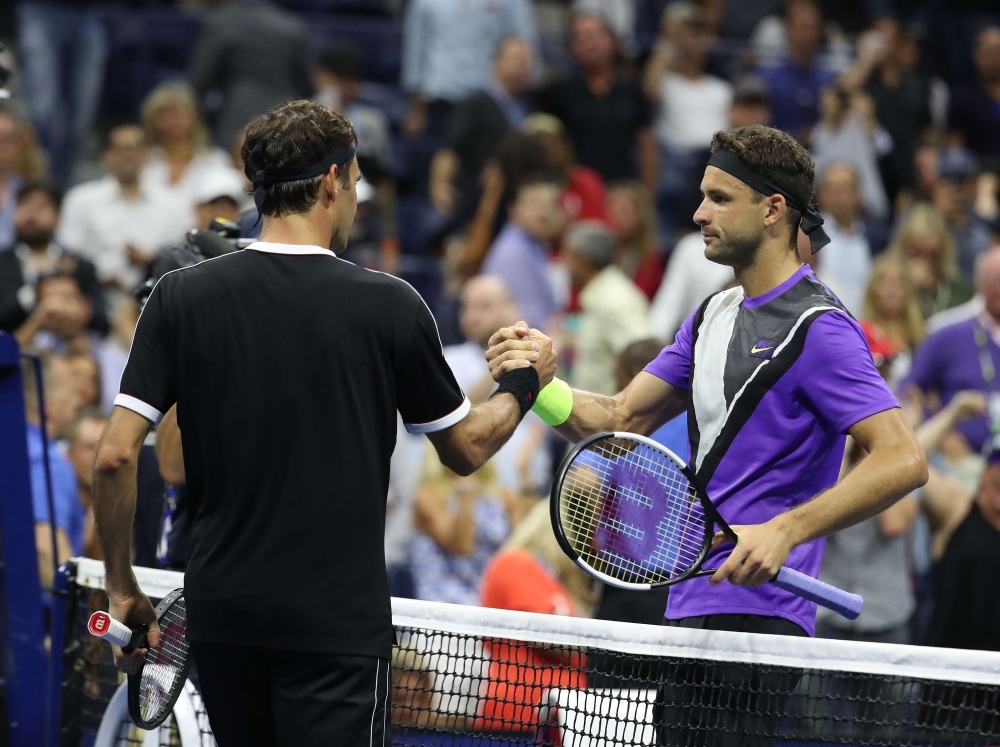 Roger Federer of Switzerland meets Grigor Dimitrov of Bulgaria after losing during his men's singles quarterfinal match on day nine of the 2019 US Open at the USTA Billie Jean King National Tennis Center in the Queens borough of New York City, on Tuesday. — AFP