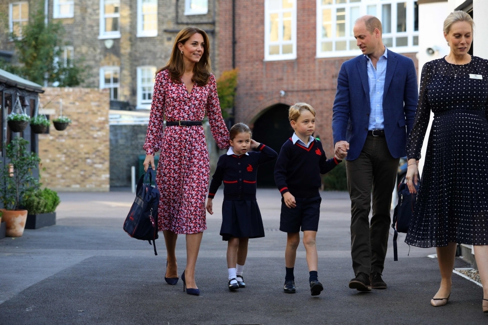 Britain's Princess Charlotte of Cambridge, accompanied by her father, Britain's Prince William, Duke of Cambridge, her mother, Britain's Catherine, Duchess of Cambridge and her brother, Britain's Prince George of Cambridge, is welcomed by Helen Haslem, head of the lower school, right, on her arrival for her first day of school at Thomas's Battersea in London on Thursday. — AFP