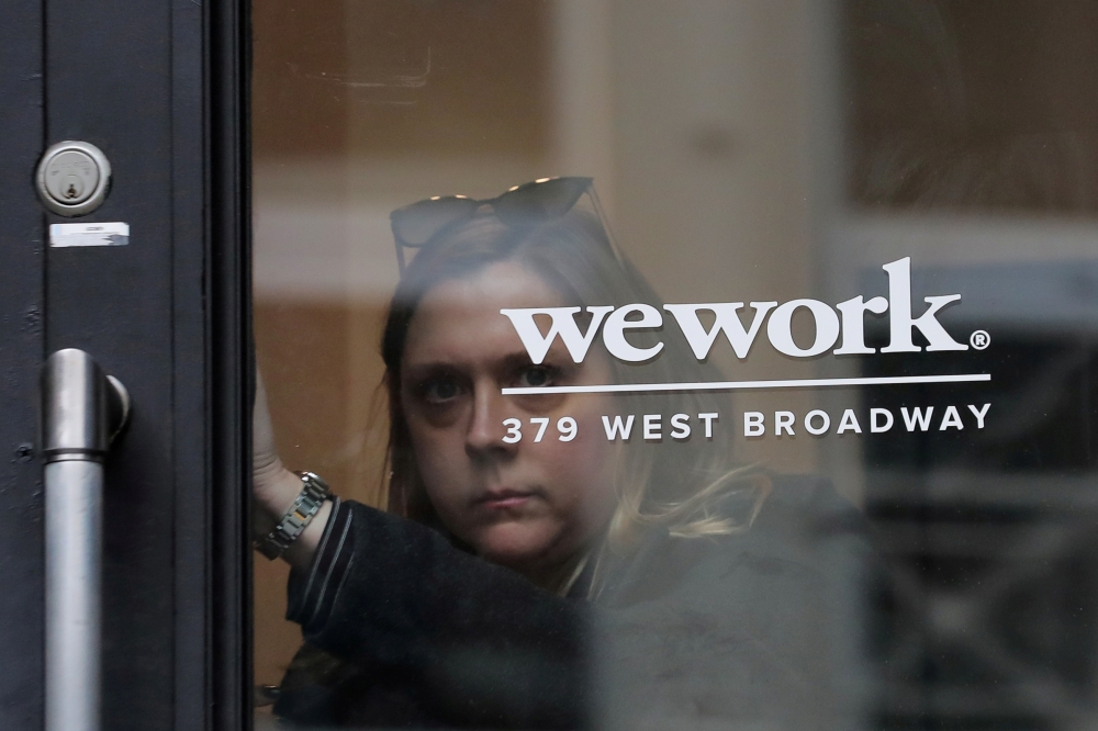 In this file photo a WeWork office is seen in New York City.  WeWork has slashed by more than half its valuation target after setting an ambitious goal for the fast-growing office-sharing startup, sources familiar with the company said on Thursday. — AFP