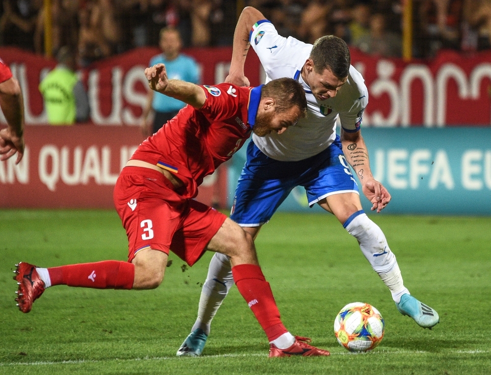 Armenia's defender Varazdat Haroyan (L) fights for the ball with Italy's forward Andrea Belotti during the Euro 2020 Group J football qualification match between Armenia and Italy at the Vazgen Sargsyan Republican stadium  in Yerevan on Thursday. — AFP