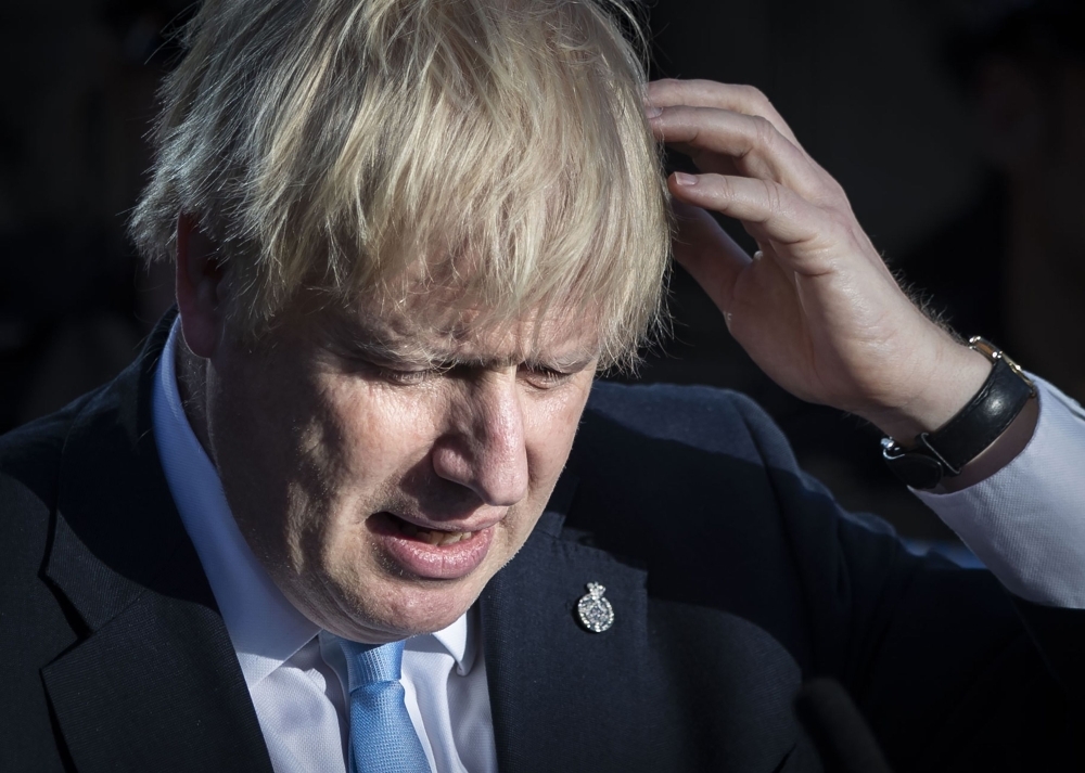 Britain's Prime Minister Boris Johnson reacts during a visit with the police in West Yorkshire, northern England, on Thursday. — AFP