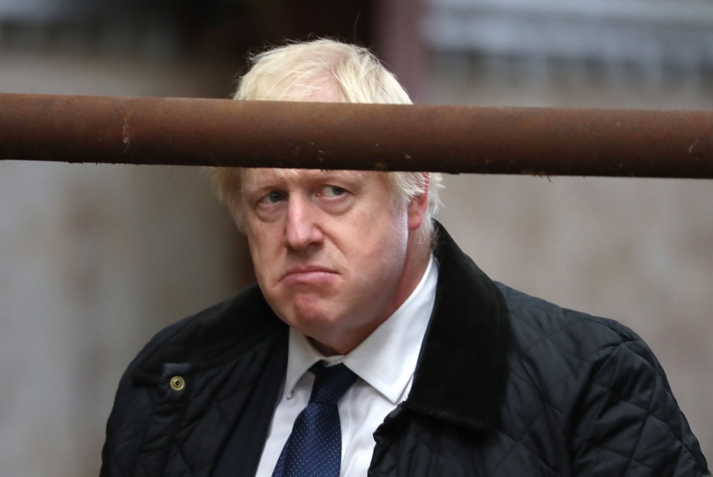 Britain's Prime Minister Boris Johnson gestures during a visit to Darnford Farm in Banchory near Aberdeen in Scotland on Friday. — AFP