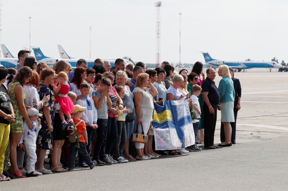 Relatives of Ukrainian prisoners, included in the Russia-Ukraine prisoner swap, wait for their arrival at Borispil International Airport outside Kiev, Ukraine on Saturday. -Reuters