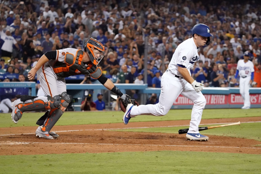 San Francisco Giants catcher Buster Posey (28) attempts to tag out Los Angeles Dodgers catcher Will Smith (16) after a dropped third strike in the ninth inning at Dodger Stadium, Los Angeles, CA, USA, on Friday. The Giants won 5-4. — Reuters