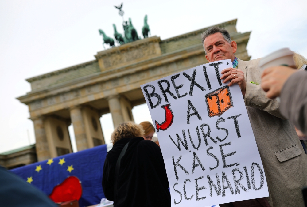 A demonstrator holds a sign during a rally under the slogan 