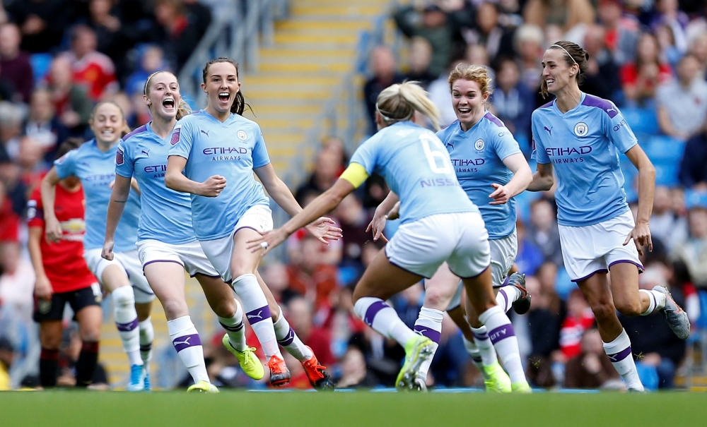 Manchester City's Caroline Weir celebrates scoring their first goal with teammates during the Women's Super League game against Manchester United at Etihad Stadium, Manchester, on Saturday. — Reuters