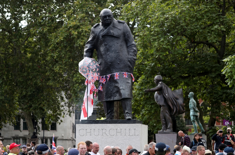 A statue of Winston Churchill is decorated by pro-Brexit protesters with English and Union Jack flags during a rally in Whitehall, London on Saturday. -Reuters