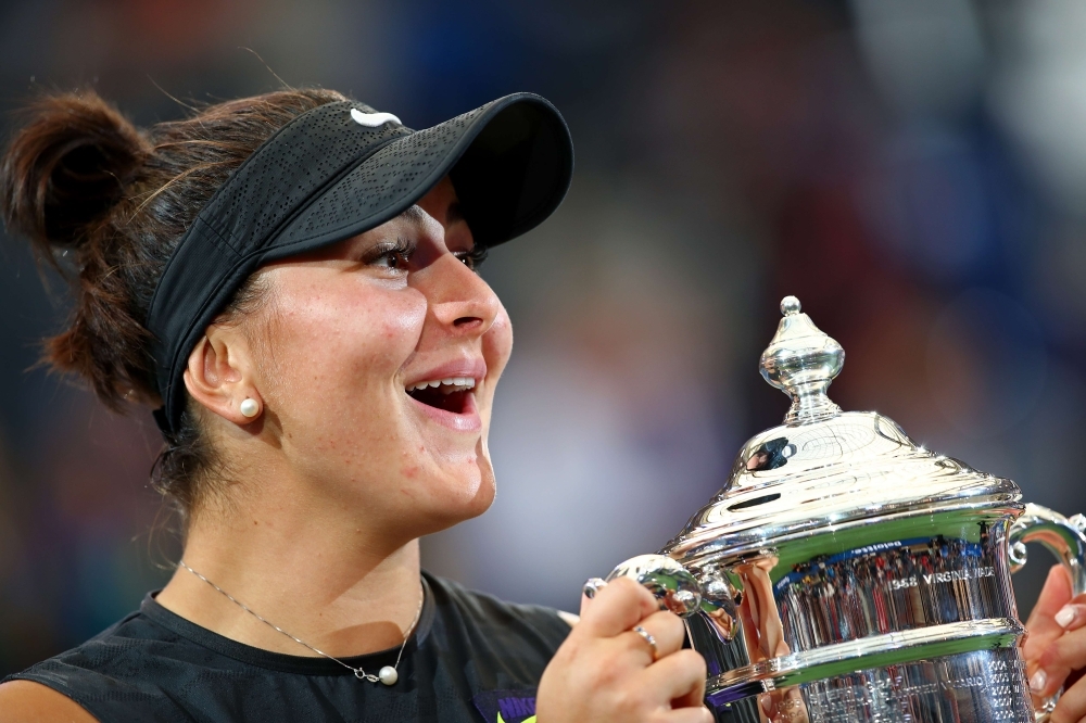 Andreescu of Canada celebrates with the championship trophy during the trophy presentation ceremony after winning the Women's Singles final against against Serena Williams of the United States on day thirteen of the 2019 US Open at the USTA Billie Jean King National Tennis Center in the Queens borough of New York City, on Saturday. — AFP