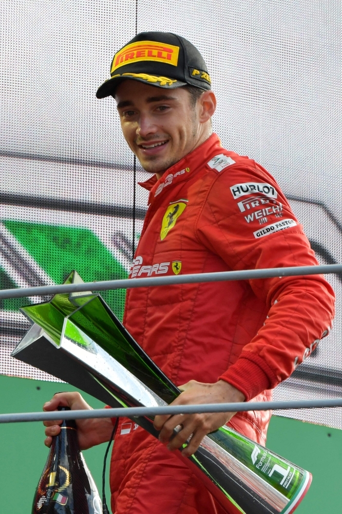 Race winner Charles Leclerc celebrate on the podium with the trophy, Formula  1 photos