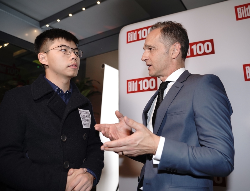Hong Kong pro-democracy activist Joshua Wong (L) talks with German Foreign Minister Heiko Maas as they attend the 