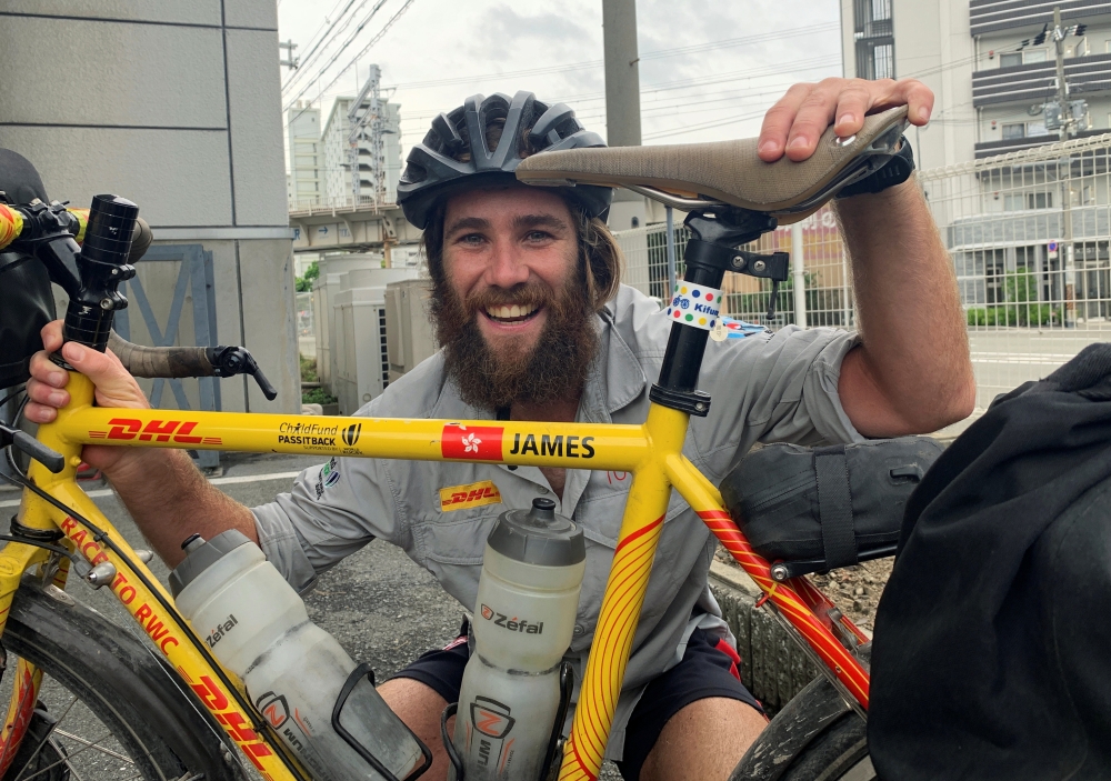 Cyclist James Owens poses with a bicycle after reaching Osaka, following almost 20,000 kilometer trip from London to deliver Rugby World Cup whistle, in Osaka, Japan on Friday. — Reuters