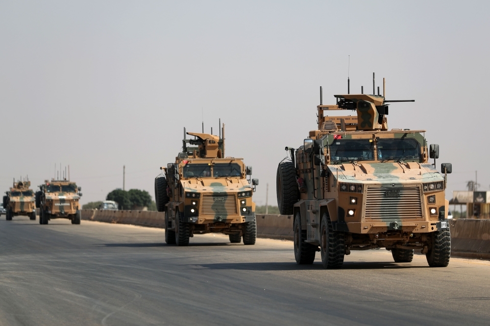 A Turkish military convoy heads toward an observation point near the town of Maar Hitat in Syria's northern Idlib province on Thursday. — AFP