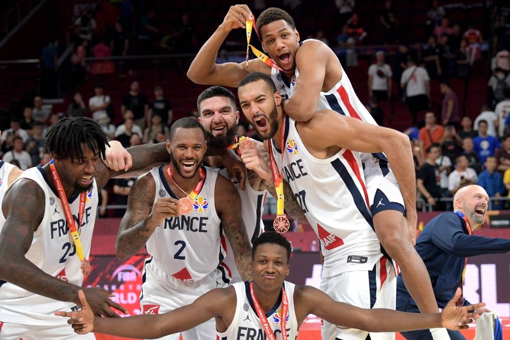 French players pose for pictures as they celebrate with their medals after their team's win against Australia at the Basketball World Cup third place game in Beijing, on Sunday. — AFP
