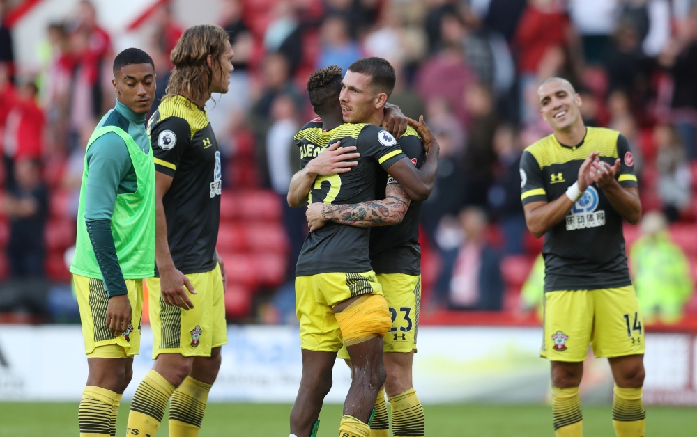 Southampton's Moussa Djenepo and Pierre-Emile Hojbjerg celebrate after the match against Sheffield United at Bramall Lane, Sheffield, Britain, on Sunday. — Reuters