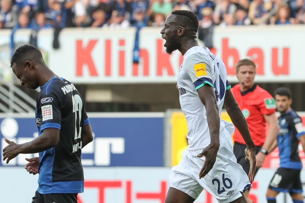 Schalke's Senegalese defender Salif Sane celebrate scoring during the German first division Bundesliga football match Paderborn v Schalke 04 in Paderborn, western Germany, on Sunday. — AFP