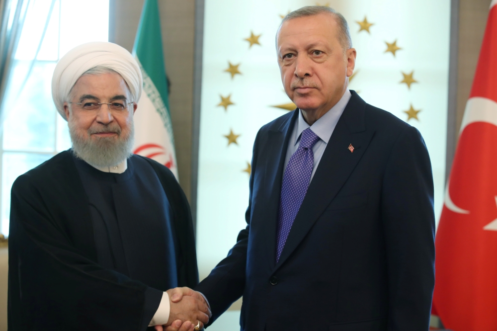 Turkish President Tayyip Erdogan, right, meets with his Iranian counterpart Hassan Rouhani in Ankara, Turkey, on Monday. — Reuters