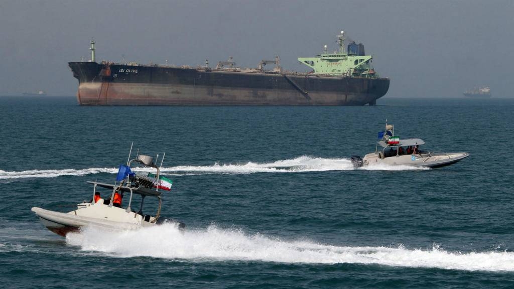 Iranian Revolutionary Guards drive speedboats in front of an oil tanker at the port of Bandar Abbas in this July 2, 2012 file photo. — AFP