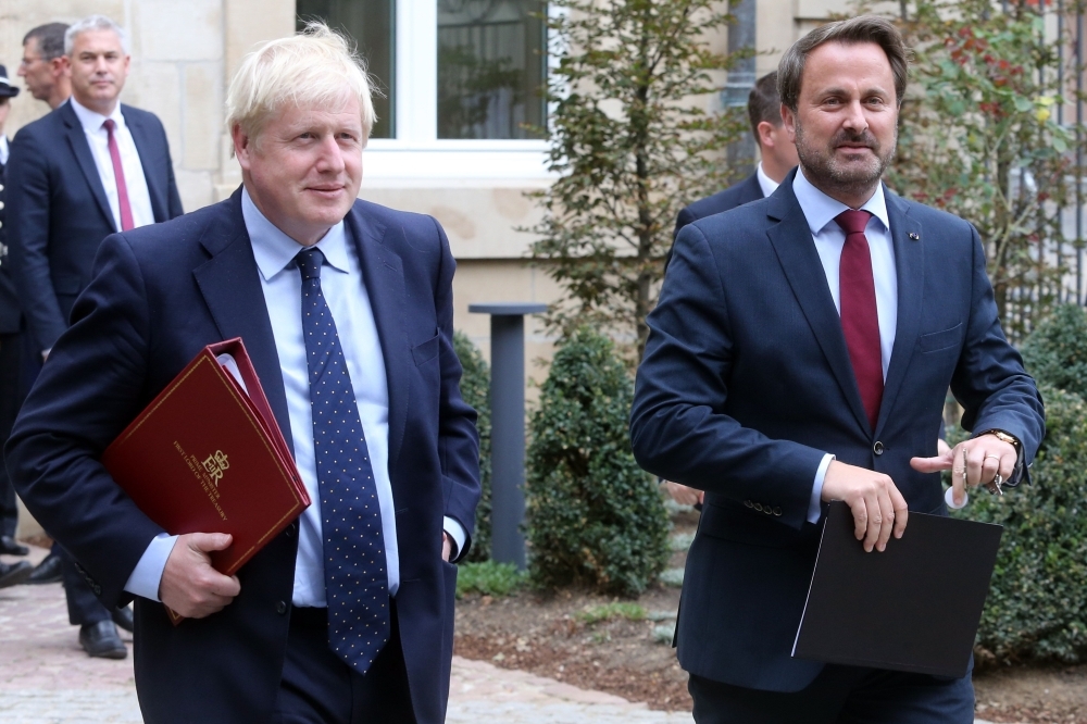 British Prime Minister Boris Johnson, left, and Luxembourg's Prime Minister Xavier Bettel, right, leave a meeting with EU Commission President and officials in Luxembourg on Monday. — AFP