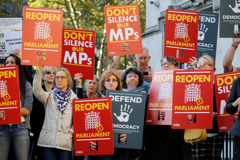 Demonstrators protest outside the Supreme Court in central London on Tuesday, the first day of the hearing into the decision by the government to prorogue parliament. -AFP  