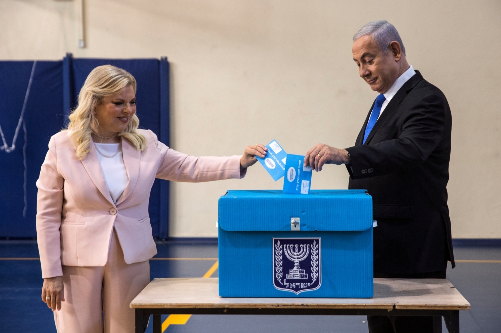 Israeli Prime Minister Benjamin Netanyahu and his wife Sara cast their vote during Israel's parliamentary election at a polling station in Jerusalem on Tuesday. — Reuters