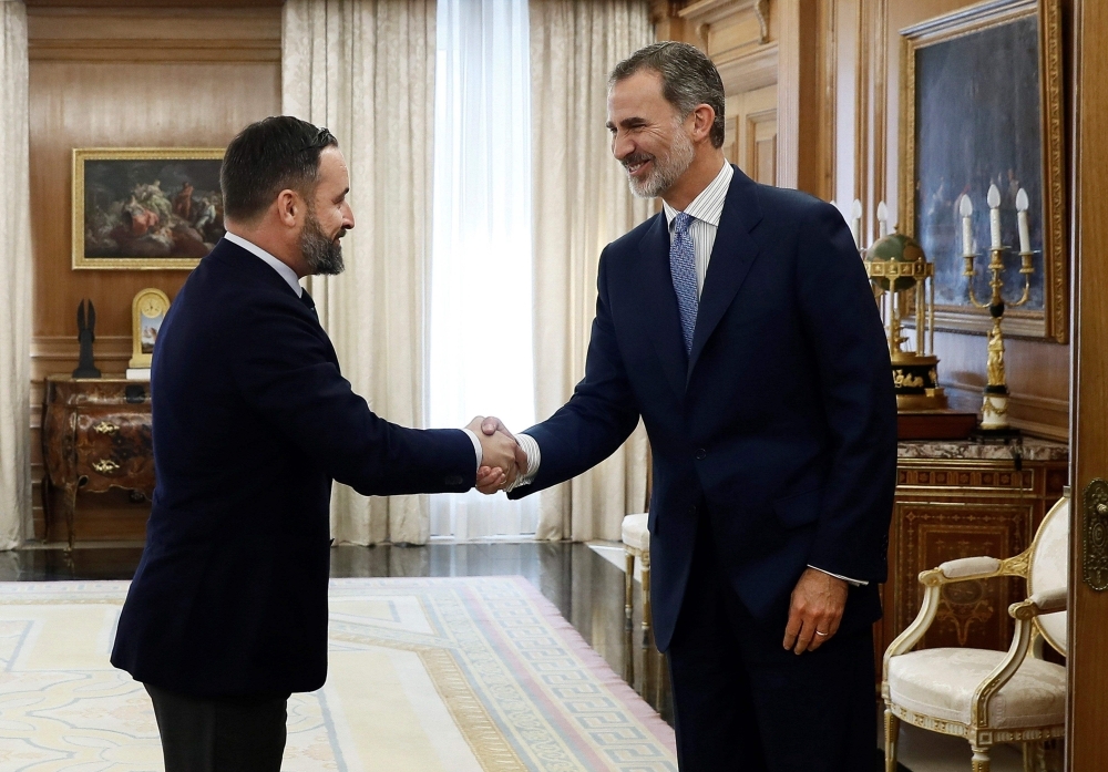 King Felipe VI of Spain, right, shakes hands with Spanish far-right party Vox leader Santiago Abascal at the Zarzuela Palace in Madrid, before a meeting ahead of the constitution of the new government, on Tuesday. — AFP