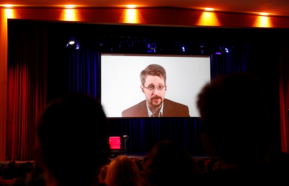 Edward Snowden speaks via video link as he takes part in a discussion about his book 