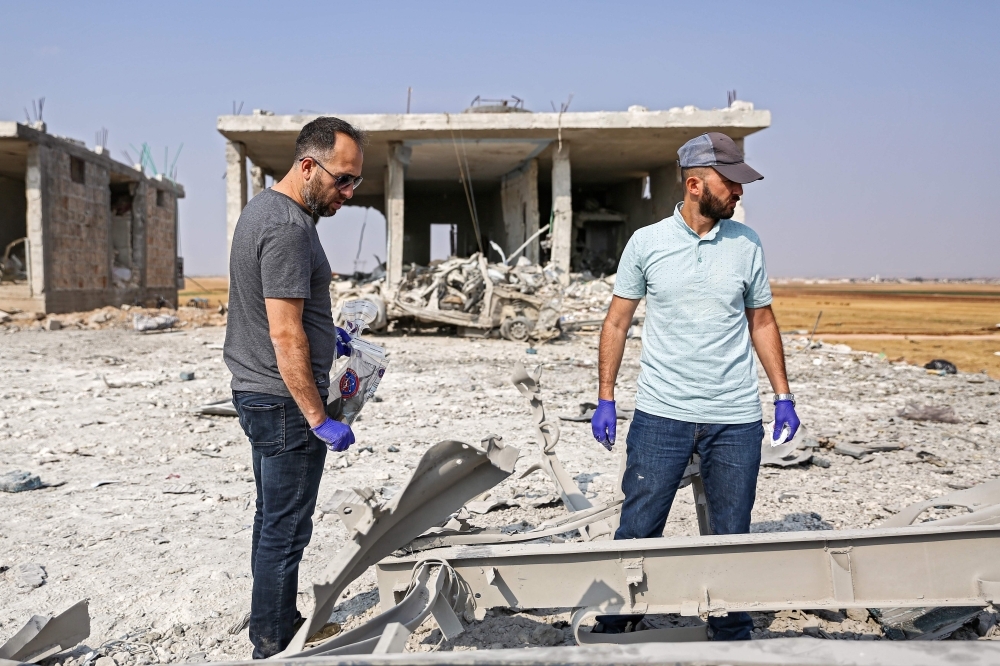 Turkish forensic experts collect samples as they inspect the scene of a rigged-car explosion in the Syrian town of Al-Rai, held by pro-Turkish Syrian fighters, in the north of Aleppo province along the border with Turkey, in this Sept. 16, 2019 file photo. — AFP