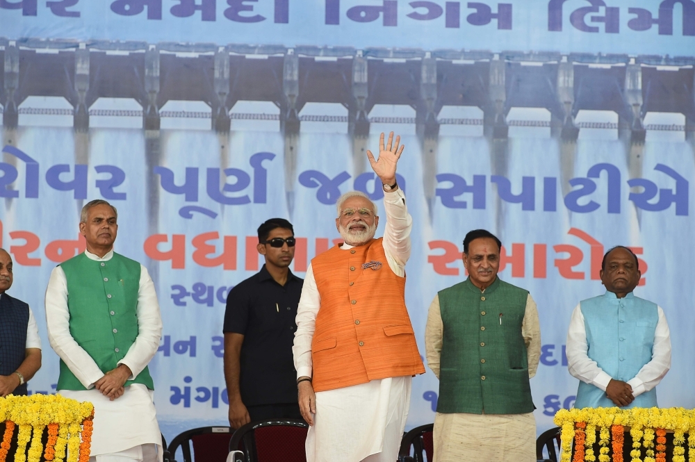 Indian Prime Minister Narendra Modi, center, waves after delivering his speech at Kevadia Colony of Narmada District, some 200 km from Ahmedabad, Gujarat, on Tuesday. — AFP