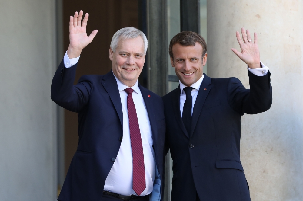 French President Emmanuel Macron (R) welcomes Finnish Prime Minister Antti Rinne upon his arrival at the Elysee presidential palace on Wednesday, in Paris. — AFP