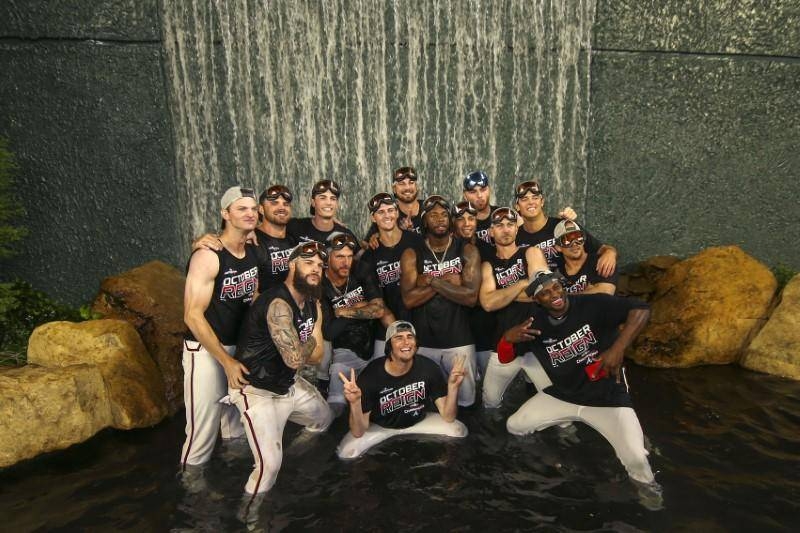 Atlanta Braves players celebrate in the fountain behind center field after clinching the NL East division after defeating the San Francisco Giants at SunTrust Park at Atlanta, GA, USA, on Friday. — Reuters