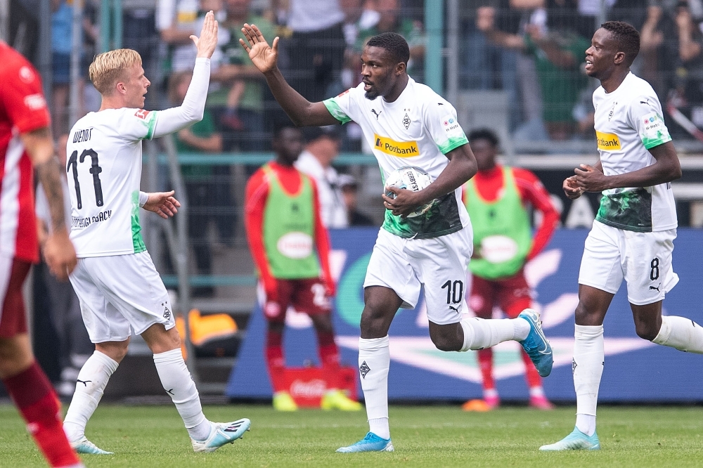 Moenchengladbach's French forward Marcus Thuram (C) celebrates with team mates after scoring the 1-1 during the German first division Bundesliga football match Borussia Moenchengladbach vs Fortuna Düsseldorf in Moenchengladbach, western Germany, on Sunday. — AFP