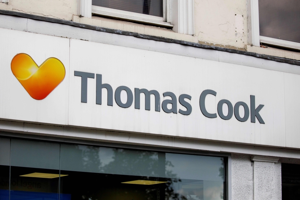 In this file photo taken on July 12, 2019, pedestrians walk past a branch of a Thomas Cook travel agent's shop in London. Thomas Cook's 178-year existence was hanging by a thread on Sunday after the iconic British travel firm struggled to find further private investment and is now relying on an unlikely government bailout. — AFP