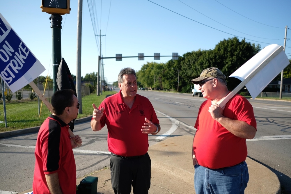 General Motors workers listen to United Auto Workers (UAW) Local 14 President Denis Earl (C) along the west side of the GM Powertrain Plant on Sept. 18, 2019 in Toledo, Ohio. GM and the UAW, which is leading its first strike against the auto maker since 2007, bargained into the evening yesterday and had plans to continue today over wages and health care, according to published reports citing sources familiar with the negotiations. — AFP