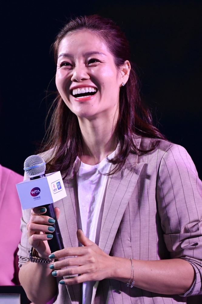 Retired Chinese tennis star Li Na speaks during the opening ceremony on the first day of action at the Wuhan Open tennis tournament in Wuhan n Sunday. — AFP