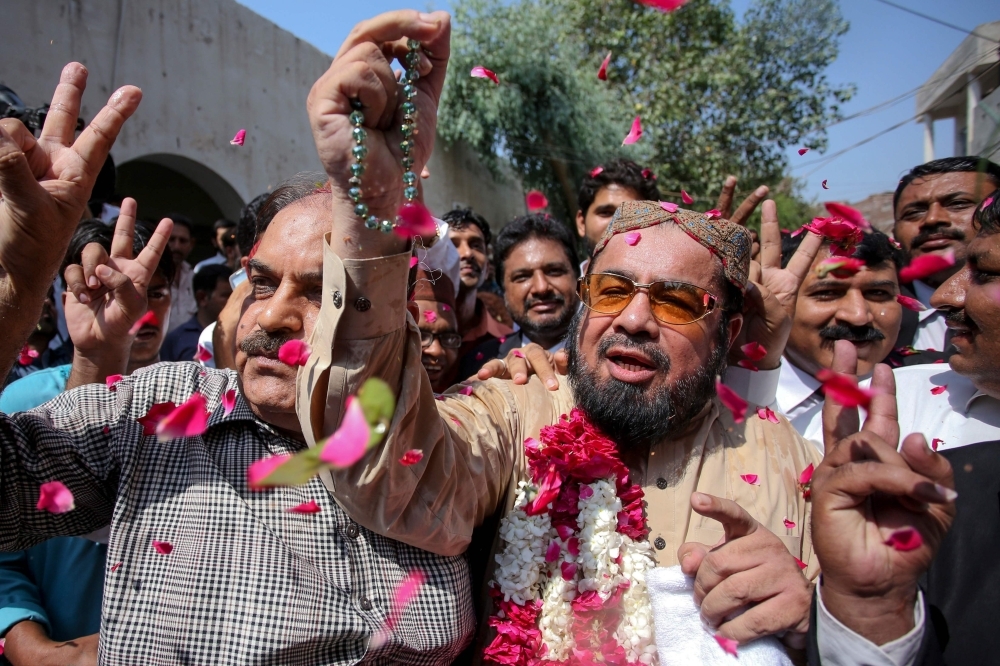 Policemen escort hand-cuffed Muhammad Waseem (C), the brother of slain social media celebrity Qandeel Baloch, as he leaves the court after the verdict in Multan on Friday. The brother of Pakistani social media star Qandeel Baloch was sentenced to life in prison for her murder — the patriarchal country's highest-profile 