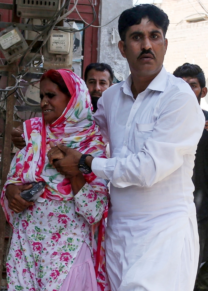 Policemen escort hand-cuffed Muhammad Waseem (C), the brother of slain social media celebrity Qandeel Baloch, as he leaves the court after the verdict in Multan on Friday. The brother of Pakistani social media star Qandeel Baloch was sentenced to life in prison for her murder — the patriarchal country's highest-profile 