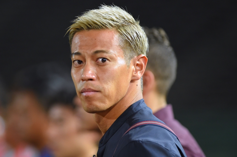 In this file photo taken on March 22, 2019, Cambodia's national football team manager Keisuke Honda watches his team during the Tokyo 2020 Olympic Games men's Asian qualifier football match between Cambodia and Australia in Phnom Penh. Japanese football star Keisuke Honda on Saturday marketed himself to Manchester United in an unusual and apparently desperate Twitter plea, as he hunts for a new club. — AFP