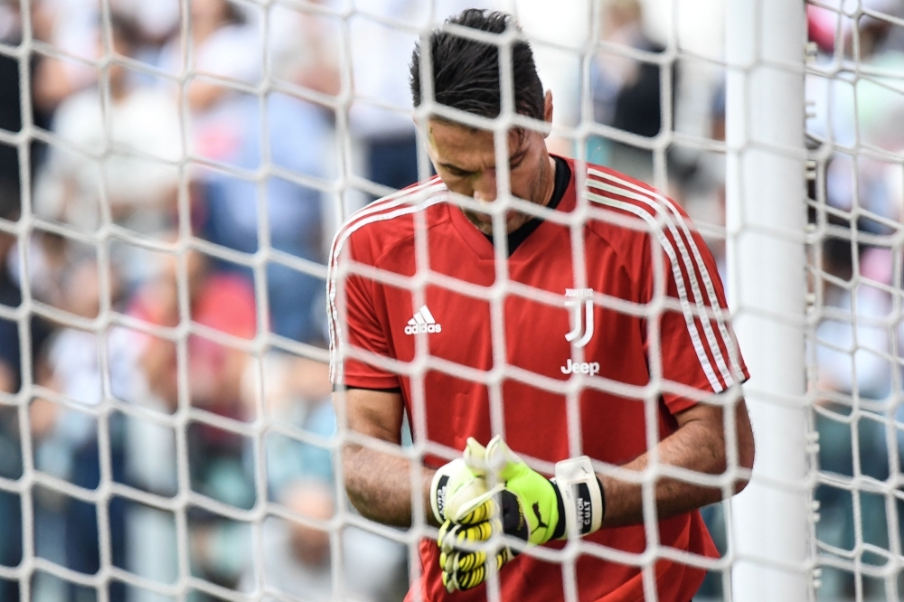 Juventus' Italian goalkeeper Gianluigi Buffon concentrates as he warms up prior to the Italian Serie A football match Juventus vs Spal on Saturday at the Juventus stadium in Turin. — AF