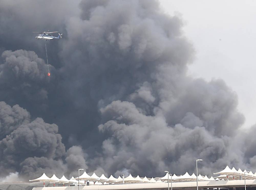 The Civil Defense forces, with the support of helicopters, battled for long hours to put out the fire that engulfed the roof of the Haramain High Speed Rail station in Sulaymaniyah district in Jeddah on Sunday. — Okaz/SG photo by Amr Sallam