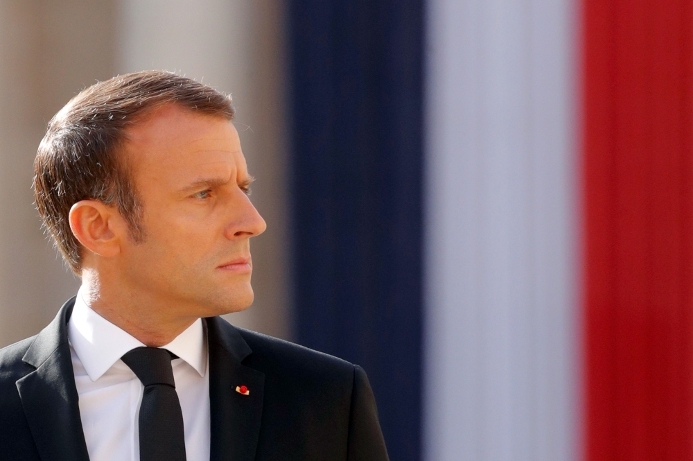 French President Emmanuel Macron walks as he attends a military tribute to former French President Jacques Chirac at the Invalides (Hotel des Invalides) in Paris on Monday. — AFP