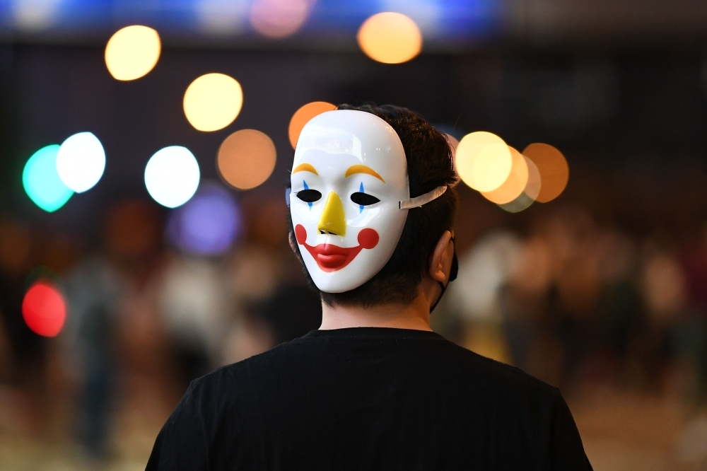 Hong Kong Chief Executive Carrie Lam (C) takes part in a press conference with her Cabinet in Hong Kong on Friday. Hong Kong's leader invoked a rarely used colonial-era emergency law to ban people from wearing face masks in a bid to put an end to months of violent protests. — AFP