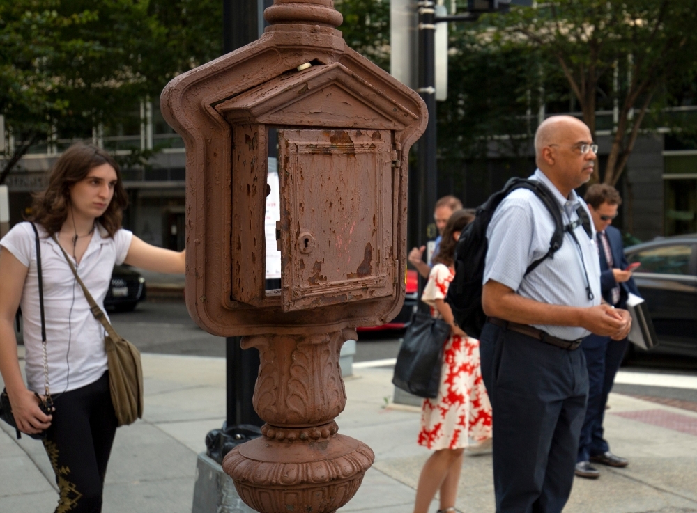 This combination of pictures created on Sept.r 16, 2019 in Washington, DC, shows old call boxes filled with art as part of the Sheridan-Kalorama Call Box Restoration Project by artists. — AFP